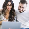 cheerful-couple-with-notebook-on-sofa1