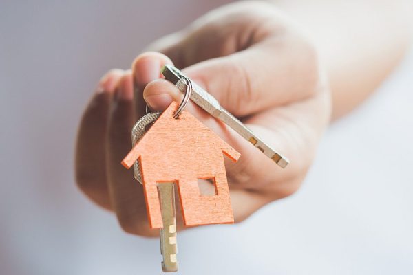 Female,Hand,Holding,House,Key,real,Estate,Agent.