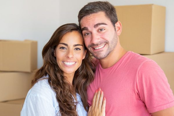 Happy young couple enjoying moving into new flat