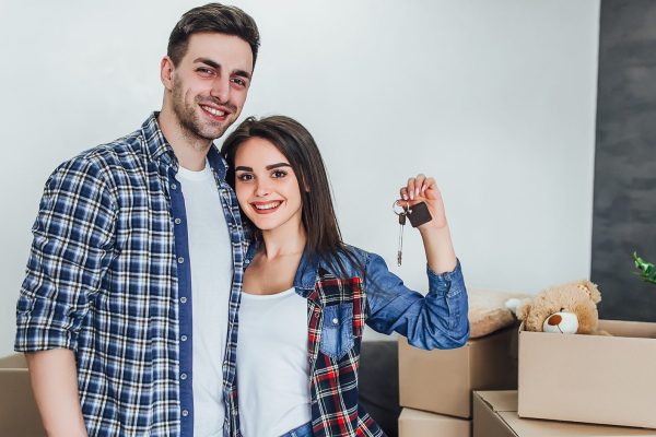 Happy couple with keys from new apartaments!