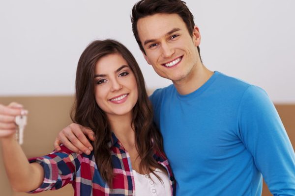 Young couple holding key in hand