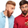 Photo of amazed surprised unshaven men stare at screen of smart phone, read sudden news on website, connected to high speed internet. Ginger bearded man and his brother isolated over white wall