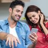 Smiling couple using phone