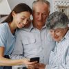 Old couple in a kitchen with young granddaughter