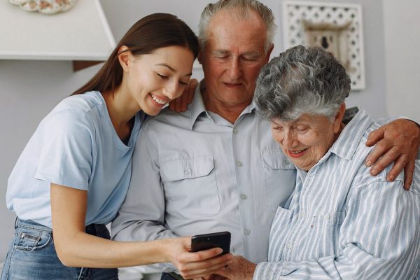 Old couple in a kitchen with young granddaughter