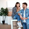 young happy man and woman in kitchen, breakfast, couple together in morning, smiling, having tea